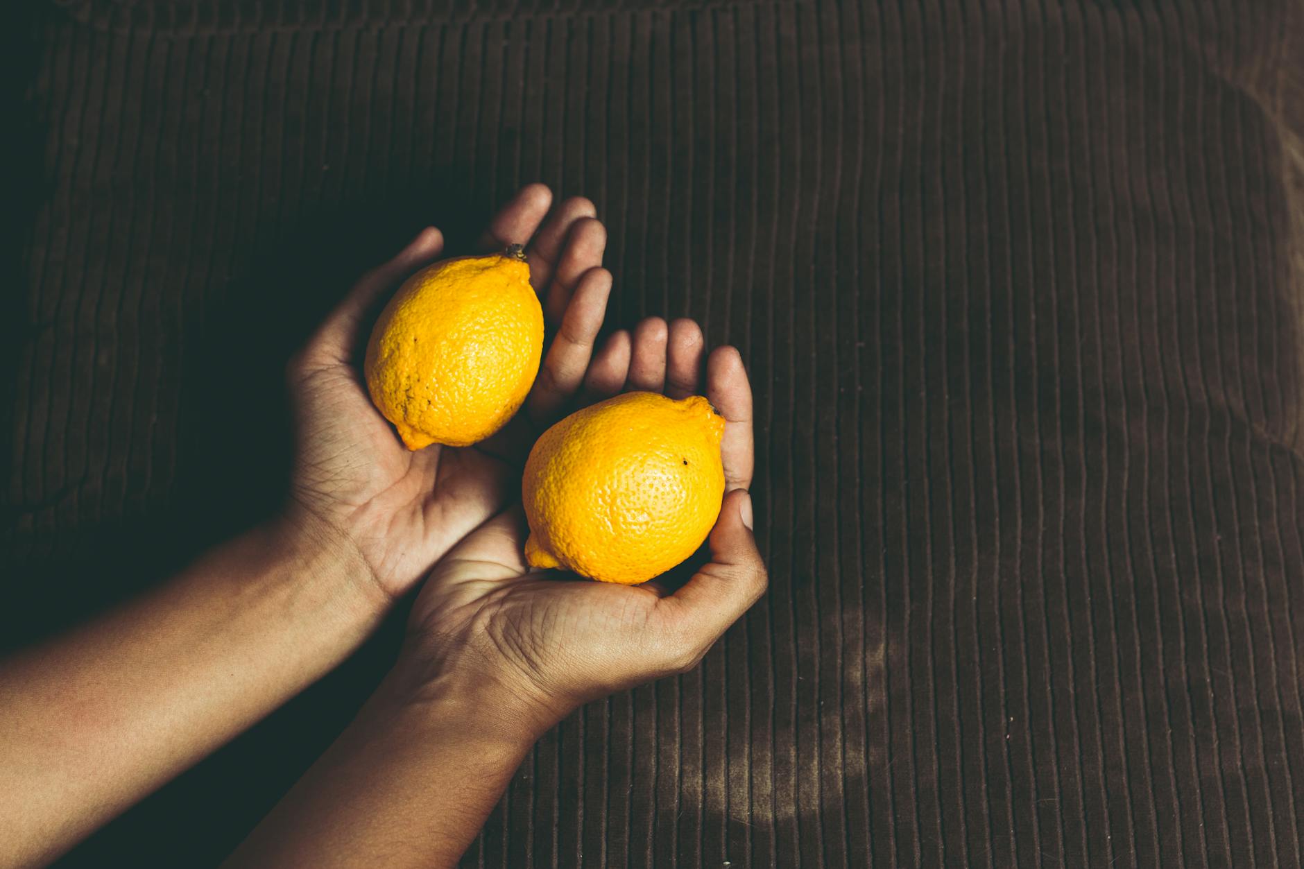 Two women enjoying themselves with fresh citrus, representing joy and vitality in aging sexuality
