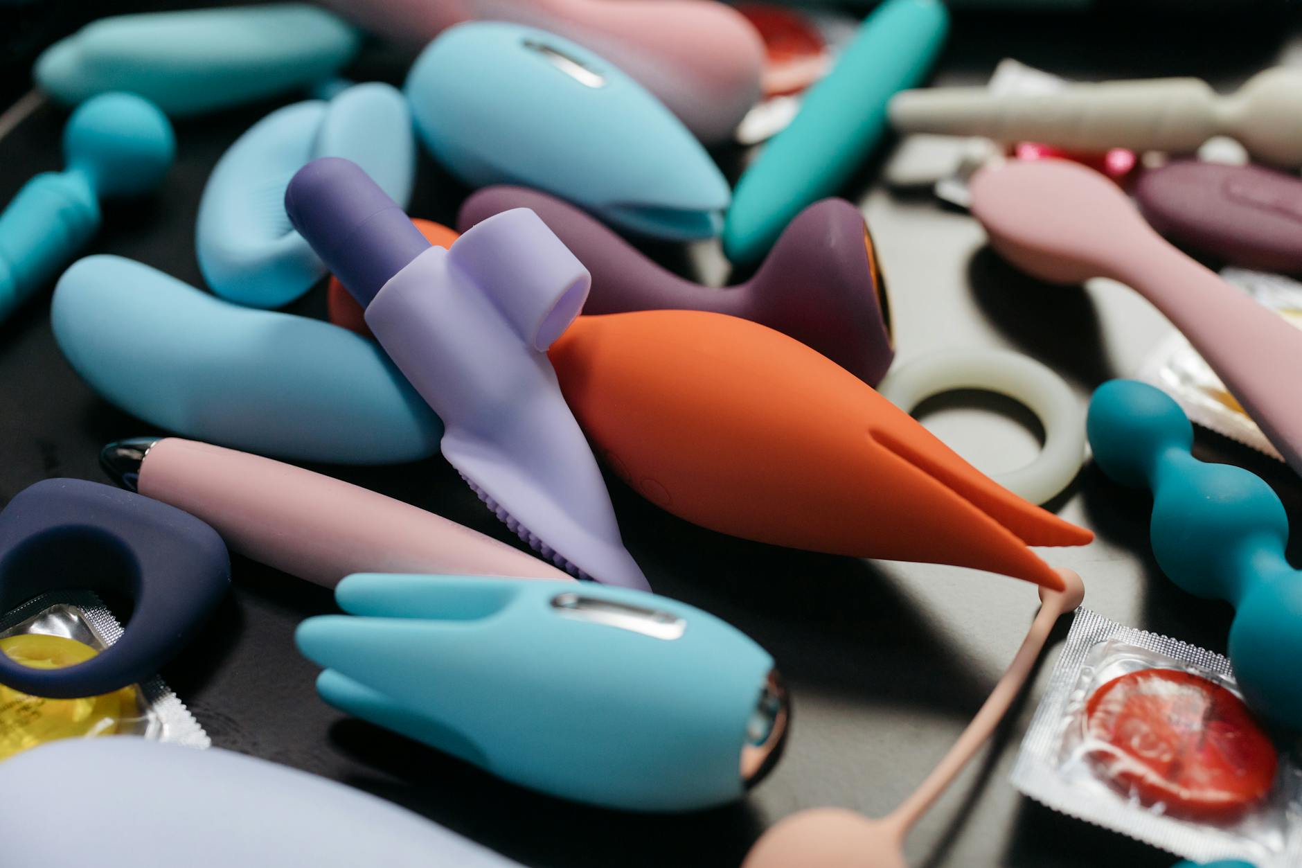 An array of vibrant adult toys including clitoral vibrators in a close-up view