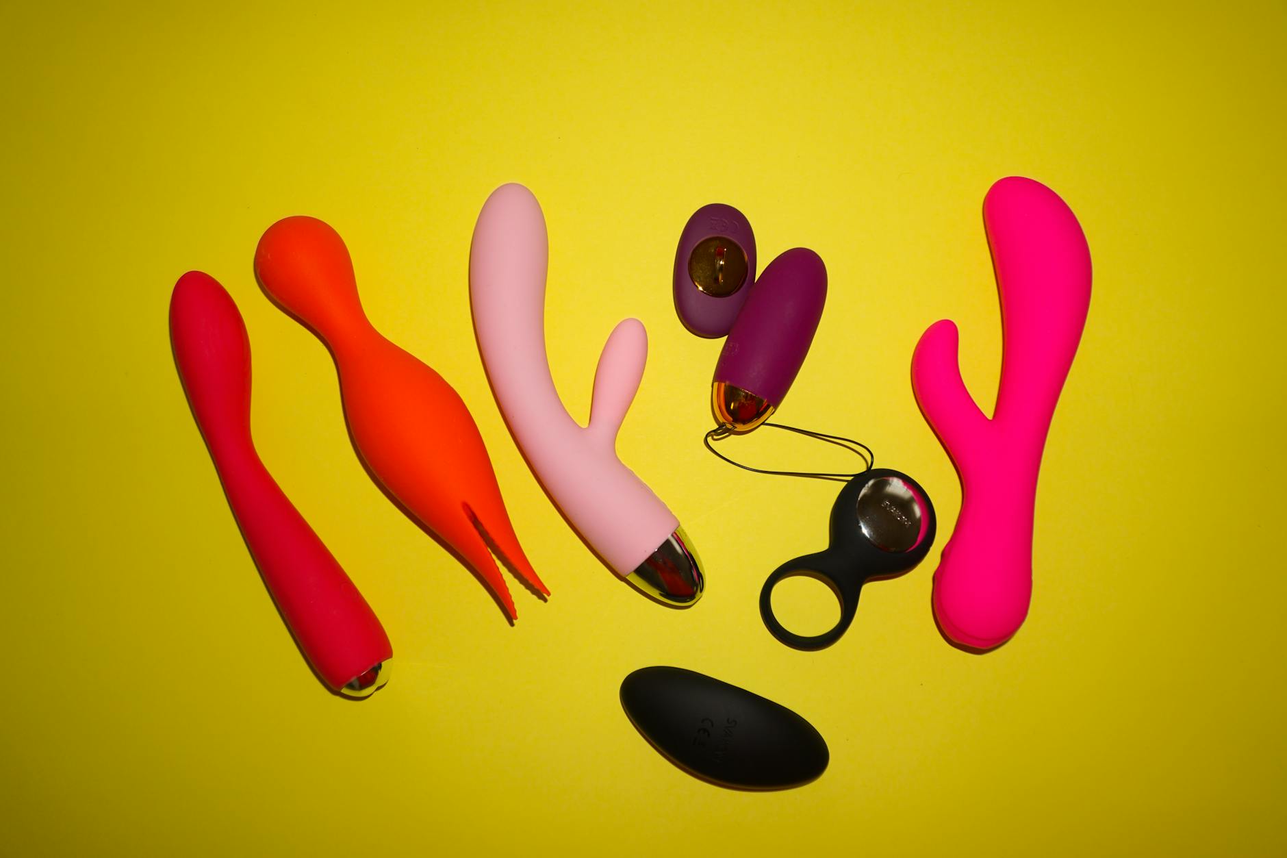Bright yellow lemon vibrator surrounded by fresh lemons on a sunny background